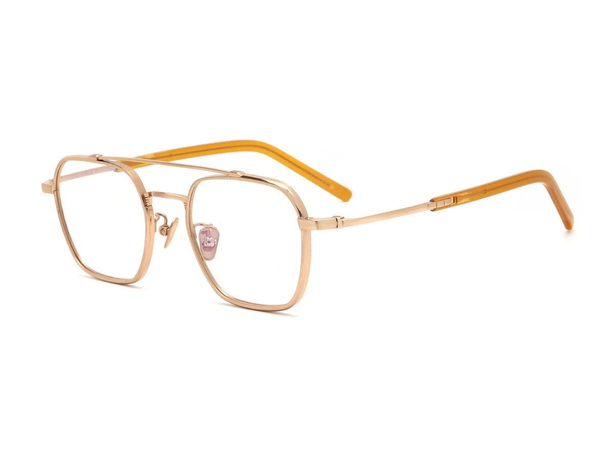 Gold pure titanium eyeglass frame model CK90311 shown at an angle