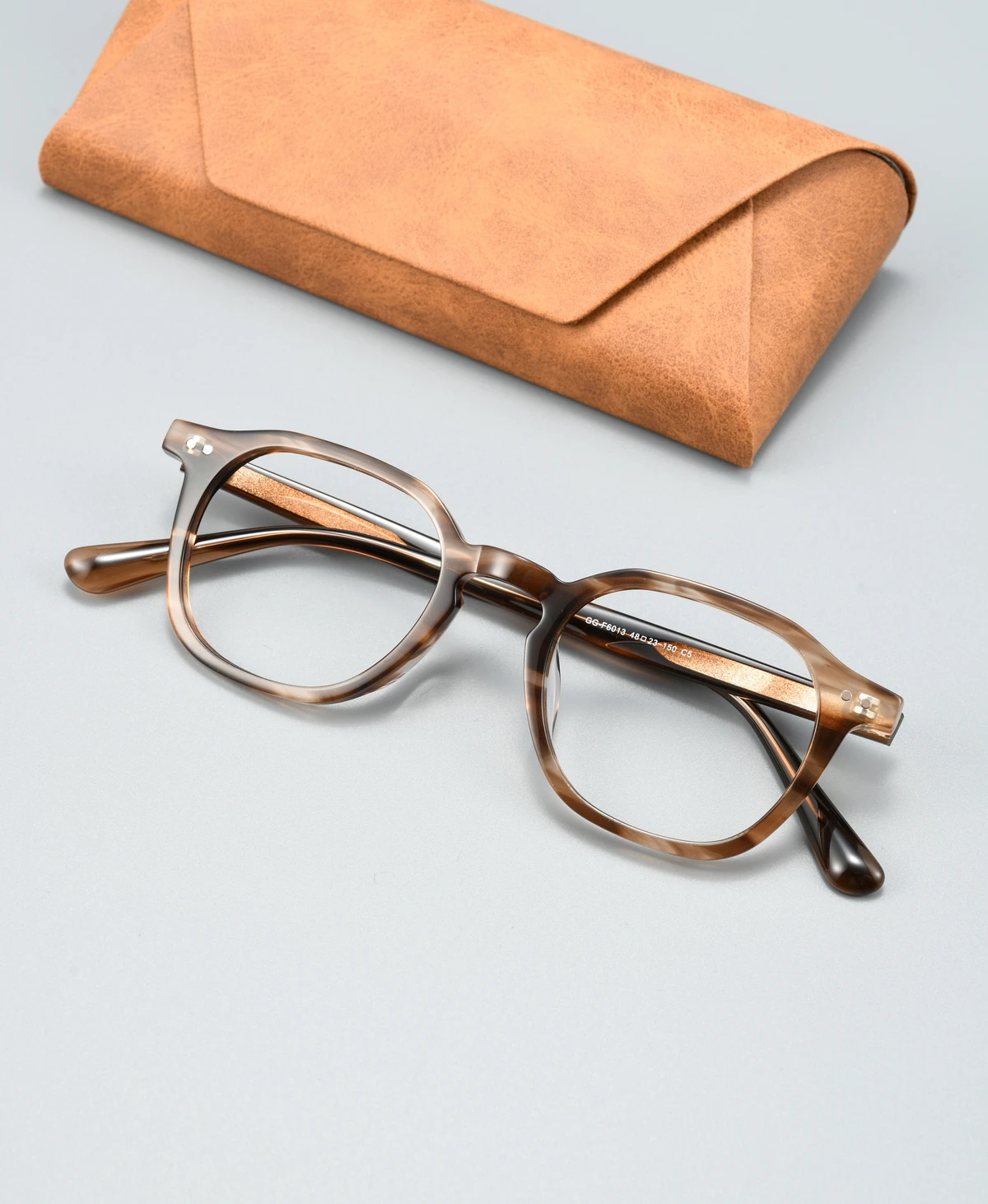 Catalog angle view of acetate eyeglass frame GG6013F with a display case