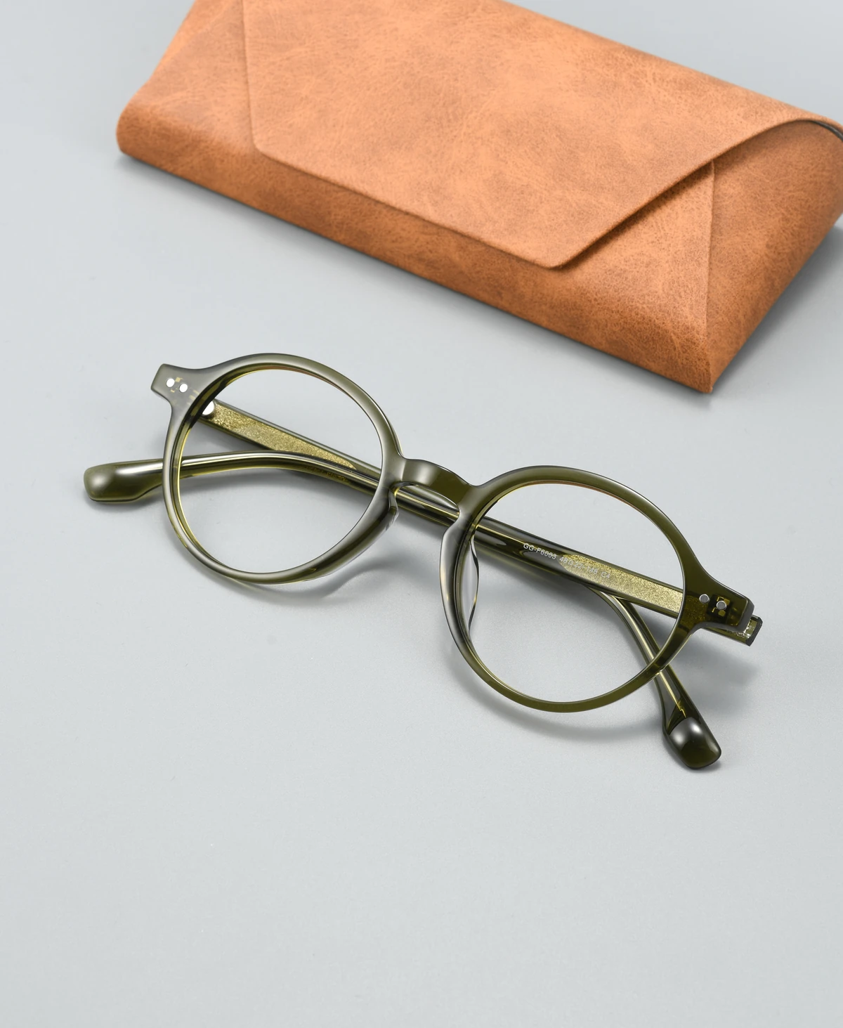 Catalog angle view of acetate eyeglass frame GGF6003BJZ with a display case