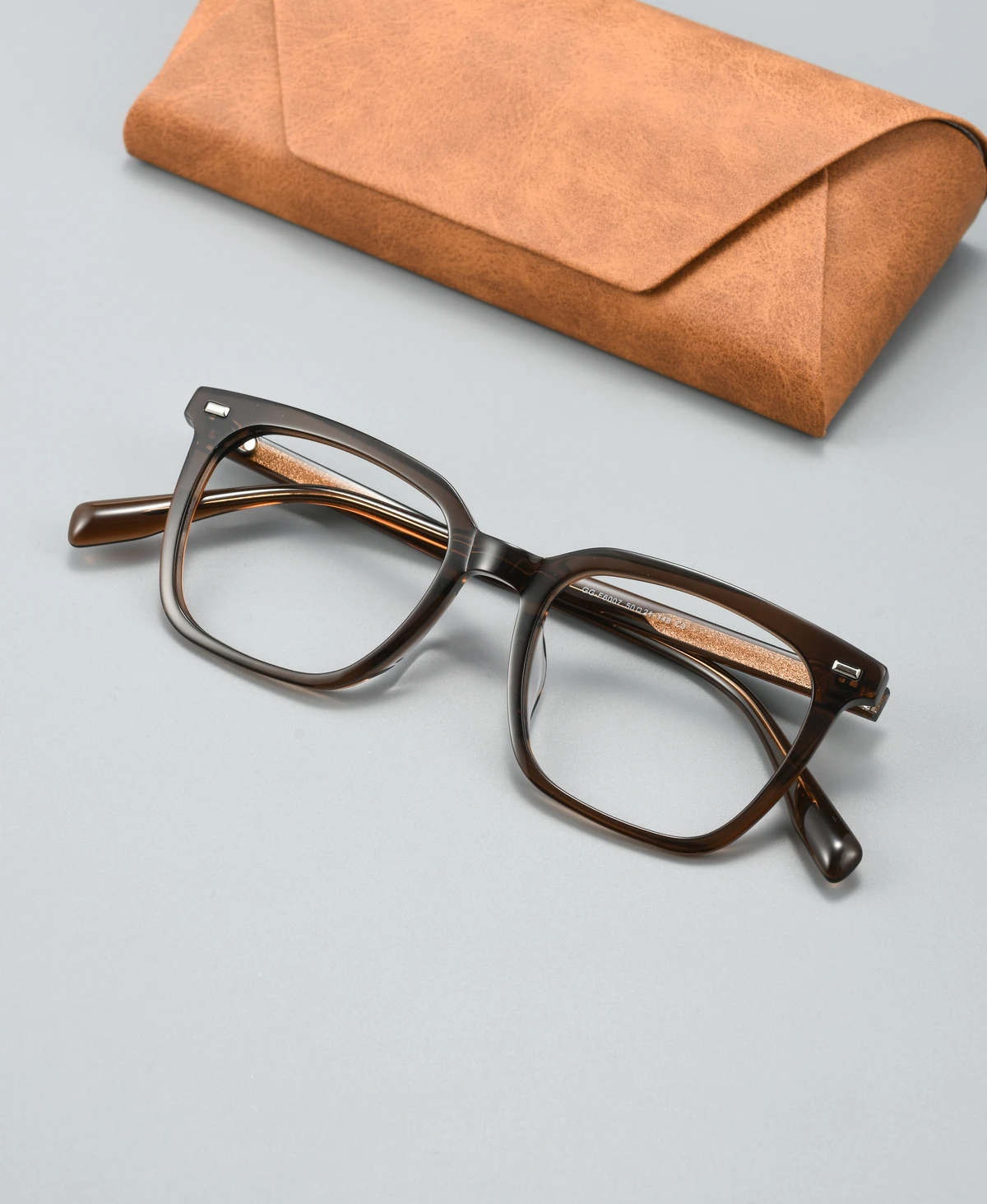 Catalog angle view of acetate eyeglass frame GGF6007BJZ with a display case